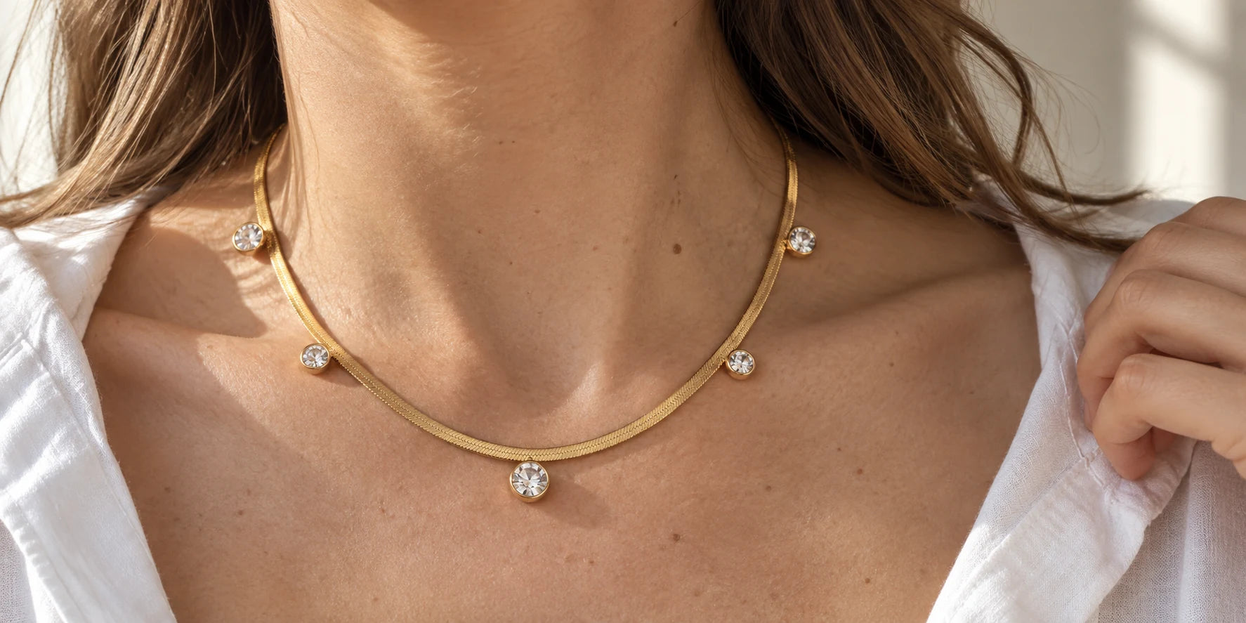 Yiyae campaign image featuring a gold necklace with five round clear charms